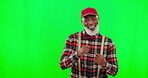 Dance, music and a funny senior black man on a green screen background in studio having fun moving to rhythm. Party, fashion and funky with a happy elderly man dancing on chromakey mockup for freedom