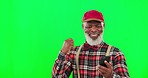 Cellphone, celebration and male in studio with green screen winning an online bet with mockup. Happy, excited and African senior man winner celebrating with a phone isolated by chroma key background.