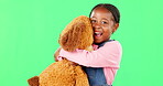 Green screen, love and a black girl hugging her teddy bear in studio in excitement or comfort. Portrait, happy and embrace with an adorable little female child holding her stuffed animal on chromakey