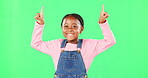 Kids, pointing and a black girl on a green screen background in studio for marketing a product. Children, portrait and advertising with a cute little female child showing space on chromakey mockup