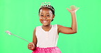 Children, wave and wand with a girl on a green screen background in studio playing fantasy or dress up. Portrait, kids and magic with an adorable little female child waving on chromakey background