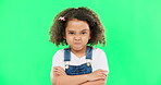 Child, angry and face with arms crossed on green screen with attitude, problem or frustrated in studio. Black kid or girl with mad, grumpy and upset or annoyed facial expression with brat tantrum