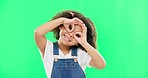 Green screen, happy and child with hands by eyes for glasses gesture for playing, happiness and fun. Emoji face, smile and portrait of girl with funny, comic and humour facial expression in studio