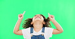 Mockup, green screen and child pointing up at product placement space isolated against a studio background. Excited, happy and portrait of young kid advertising and marketing showing deal or sale