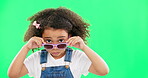 Portrait, green screen and a girl looking over her glasses in studio to ask a question with attitude. Kids, fashion and eyewear with an adorable little female child on chromakey mockup for style