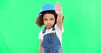 Stop, construction and face of a child on a green screen isolated on a studio background. Safety, security and portrait of a girl kid with a warning hand for building, renovation and maintenance