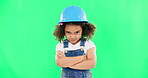 Portrait, green screen and an angry girl construction worker standing arms crossed in studio while feeling annoyed. Kids, building and an upset young female child engineer looking mean on chromakey