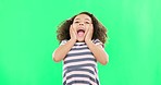 Girl, child and screaming on green screen in studio isolated on a background. Excited, happy face and kid shouting for joy, happiness and spinning for celebration, good news or cheering on chroma key