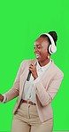 Black woman, dancing with phone and headphones on green screen, listen to music with fun and rhythm. Professional female with online streaming, tech and radio with freedom on studio background