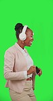 Black woman, dance with mobile phone and headphones on green screen, listen to music with fun and rhythm. Professional female with online streaming, tech and radio with freedom on studio background