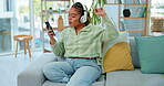 Woman with phone, headphones and dancing while listening to music on work break and relax in office social space. Singing along to radio, online streaming and wifi with energy, fun and rhythm