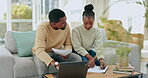 Black couple, laptop and documents for mortgage, expenses or financial budgeting on sofa in living room at home. African American man and woman reading bills, paperwork or finance on computer indoors