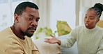 Black couple, argument and talking on sofa in disagreement, conflict or divorce in living room at home. Upset African American man and woman in fight for communication, disagree or arguing on couch
