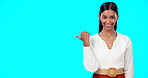 Business woman, pointing and face of a Indian female in a studio gesture to mockup for advertisement. Idea, happiness and smile of a corporate employee point thumb to show mock up advertising