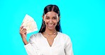 Rich, happy and face of a woman with money isolated on a blue background in a studio. Smile, wealth and a portrait of a girl fanning with cash, lottery jackpot and dollars from a bonus on a backdrop