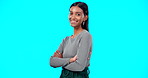 Face, smile and business woman with arms crossed in studio isolated on a blue background. Boss, professional and happy, funny and confident female entrepreneur from India with pride for career or job