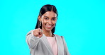 Portrait, pointing and you with a woman on a blue background in studio for option, selection or choice. Smile, happy and we are hiring with a young female employee in business making a decision