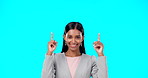 Face, employee and Indian woman with motivation, direction and happiness against a blue studio background. Portrait, female entrepreneur or lady with decision, inspiration or choice with joy or smile