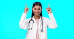 Hospital doctor, studio and happy woman point at medical promotion, healthcare notification or clinic announcement mockup. Nurse portrait, advertising surgeon and marketing person on blue background