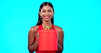 Gift box, retail and happy studio woman with sales product, discount birthday deal or Valentines Day present. Commerce market portrait, store container and luxury person isolated on blue background