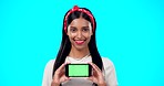 Green screen, face and phone by gen z woman in studio for advertising, space and on blue background. Smartphone, display and portrait of girl fashion influencer showing social media, blog or website