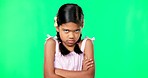 Angry, crossed arms and face of child on green screen with upset, disappointed and anger expression. Emoji, mockup studio and portrait of isolated young girl mad, unhappy and shake head for problem