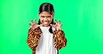 Playful, lion and face of a child on a green screen isolated on a studio background. Halloween, happy and portrait of a girl pretending to be a tiger in a onesie, playing and scary with mockup