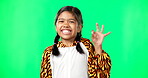 Children, perfect and hand gesture with a girl on a green screen background in studio feeling good. Portrait, smile and emoji with an adorable happy female child on chromakey mockup looking positive