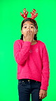 Child, christmas and shocked on green screen for secret or sale studio background. Face of girl kid with antlers headband and hand on mouth for holiday celebration announcement, surprise or portrait