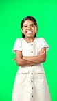 Happy, face and child in studio with green screen standing with crossed arms for confidence. Happiness, smile and portrait of girl kid model with cute and adorable expression by chroma key background