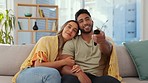 Couple watching tv together, relax and hug, quality time at home, movie and remote control with streaming service. Love, partnership and man with woman on sofa, interracial relationship and care