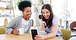 Coffee shop, phone and woman friends on a video call, waving while talking to a contact online. Cafe, mobile or virtual communication with a young woman and friend chatting in a cafe or restaurant