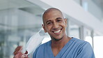 Happy, face and a doctor removing mask for end of pandemic, surgery or medical procedure. Smile, portrait and a male nurse excited about freedom from covid, virus and restrictions at a hospital