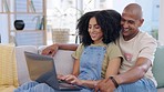 Love, laptop and couple relax on a sofa, happy and embrace while enjoying home entertainment or subscription. Online, streaming and man with woman on a couch cheerful, smile and bonding with movie 