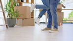 Couple, legs and hug in real estate moving, new home or relationship goals in living room floor. Leg and feet of man lifting woman the ground in joy for house loan, property or ownership together