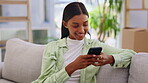 Phone, social media and text message with a woman on a sofa in the living room of her to relax over the weekend. Contact, mobile and app with an attractive young female texting or chatting online