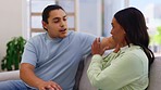 Couple, argument and fighting in conflict on sofa in living room dispute arguing at home. Angry woman and man upset in breakup, affair or relationship problems in disagreement on lounge couch indoors