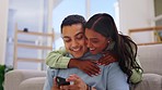 Love, hug and couple on couch, smartphone and social media with choice, connection and conversation. Romance, man and woman on sofa, cellphone and planning date in living room, smile and relationship