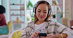 Phone music, headphones and woman employee streaming audio at office feeling relax with smile. Web radio, sofa and happiness of a young female in a lounge on a couch listening to a track and podcast