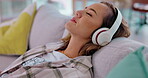 Relax, headphones and woman on couch for music streaming, mental health and sleeping for home wellness. Young person in lounge or sofa listening to calm or zen radio on audio technology and internet