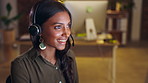 Crm, communication or Indian woman consulting in call center helping, speaking or talking at customer support. Computer, night or sales consultant in telemarketing or telecom company with advice