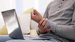 Closeup man, wrist pain and injury at laptop from osteoporosis, orthopedic and typing. Male, hands and carpal tunnel from fatigue, health risk and arthritis of muscle, fibromyalgia and osteoarthritis