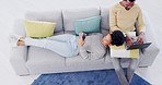 Couple, top view and living room with laptop, phone and relax on sofa together with social media. Black man, woman and technology for bonding, communication or work from home with computer in lounge