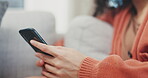 Hands, woman and typing on smartphone in lounge, social media and reading digital notification. Closeup female, cellphone and texting in house, download mobile games and search web app on technology