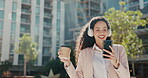 Headphones, city and dancing woman on coffee break for outdoor wellness, energy and career happiness. Walking employee, worker or biracial person listening to music on cellphone in urban outdoor park