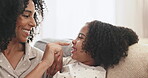 Happy, nose or playful with a mother and daughter bonding on a sofa in the living room of their home. Family, love or laughing and a woman playing with her girl child while in a house together