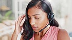 Stress, headache and a woman in a call center for support, angry consulting and tired of telemarketing. Anxiety, fatigue and a customer service agent talking while working as an online consultant