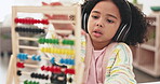 Education, elearning and girl with headphones and abacus, counting and math with school and distance learning. Childhood development, growth and kindergarten, study and child with numbers homework