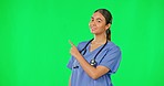 Healthcare, green screen and woman doctor pointing at advice, information or health announcement. Help, medicine and hispanic medical professional presentation of hospital info on studio background.