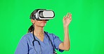 Green screen, virtual reality and doctor with headset in studio for telehealth, user interface and medical research. Healthcare, futuristic tech and woman touch invisible screen, cyber and network